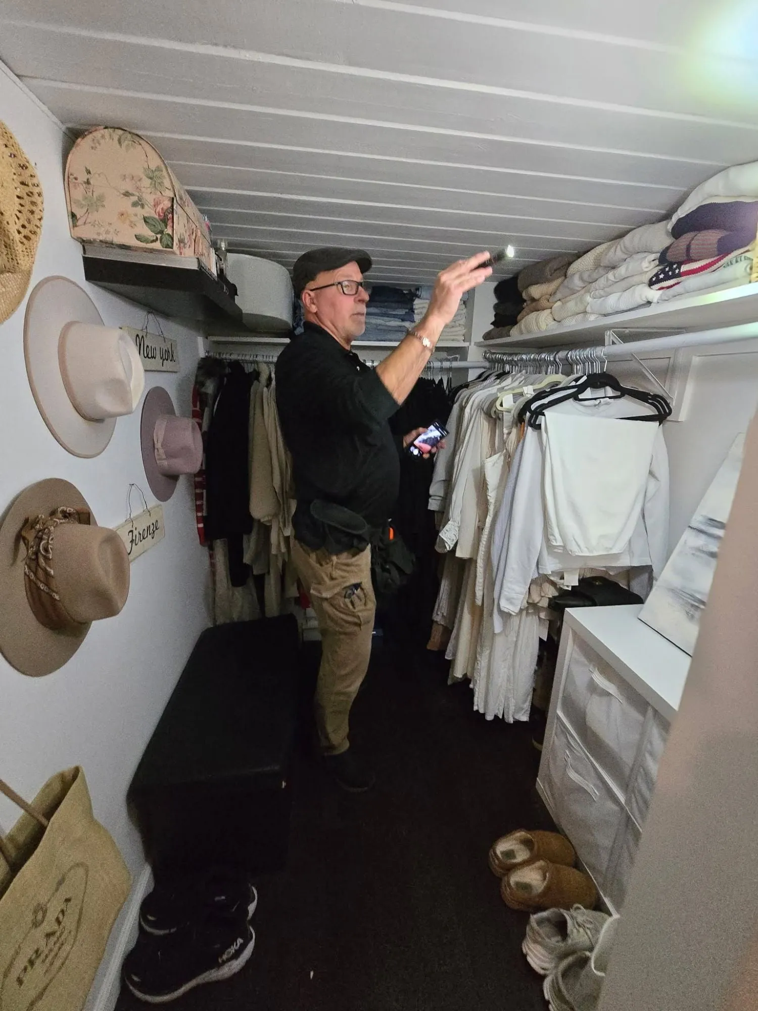 Eagle Eye inspector Lance Kotash checking a closet ceiling with a flashlight during an inspection